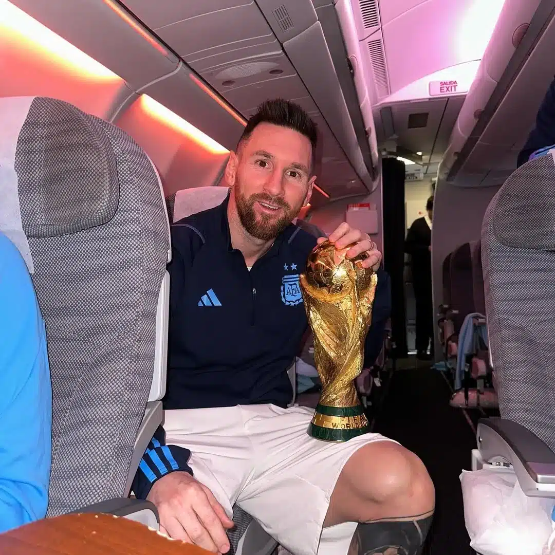 Messi on Airplane with Trophy